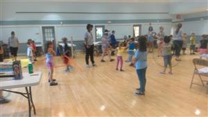 Children engaged in fun activities while playing in a spacious room.