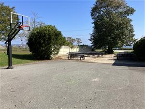 Outside Picnic Area of Ft. Taber, Basketball Hoop & Tables on Cement Area